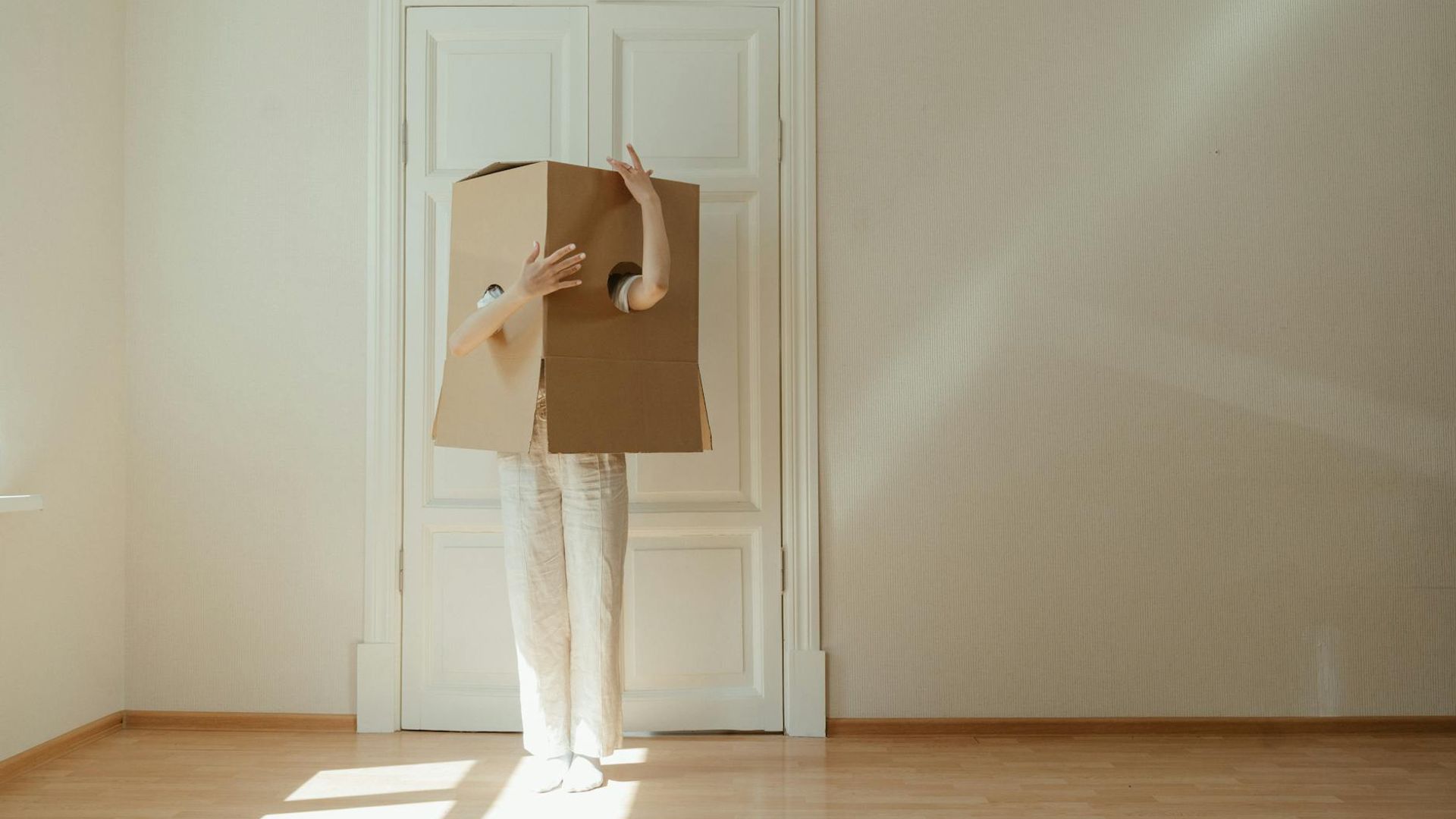 Person performing a calm, flowing movement in a minimalist space.